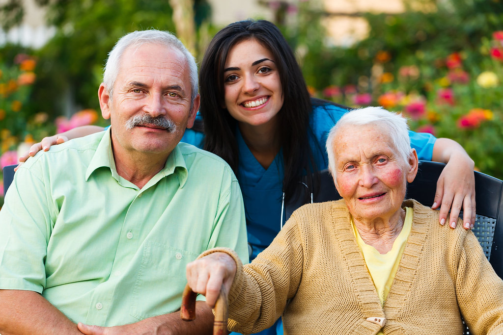 A happy family with their carer in the garden