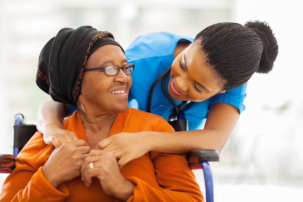 A nurse sharing a smile with a senior patient